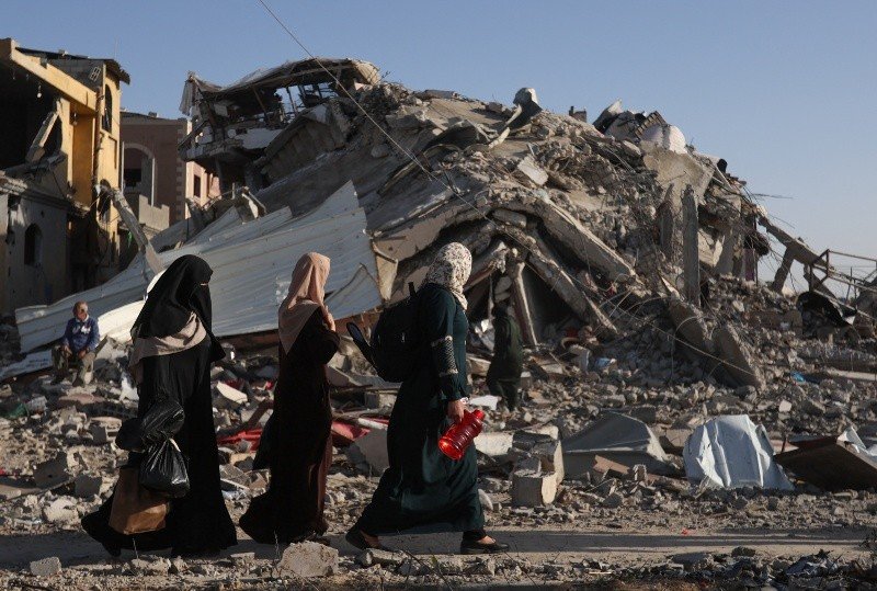 Los palestinos desplazados regresan a sus hogares mientras caminan cerca de casas destruidas en un ataque israelí durante el conflicto, en medio de la tregua temporal entre Hamas e Israel, en Jan Yuni, en el sur de la Franja de Gaza, el 24 de noviembre de 2023. REUTERS/Ibraheem Abu Mustafa Los palestinos desplazados regresan a sus hogares mientras caminan cerca de casas destruidas en un ataque israelí durante el conflicto, en medio de la tregua temporal entre Hamas e Israel, en Jan Yuni, en el sur de la Franja de Gaza, el 24 de noviembre de 2023. REUTERS/Ibraheem Abu Mustafa